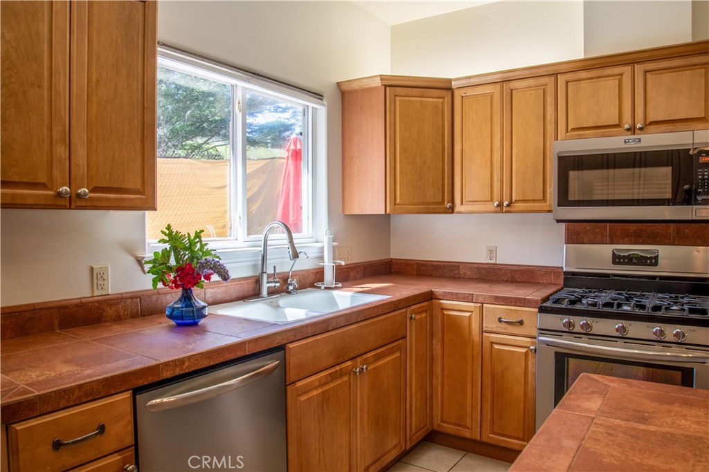 3199 Eton Road Cambria, CA 93428 - Photo 11 of 30 a kitchen with stainless steel appliances granite countertop a sink a stove and cabinets