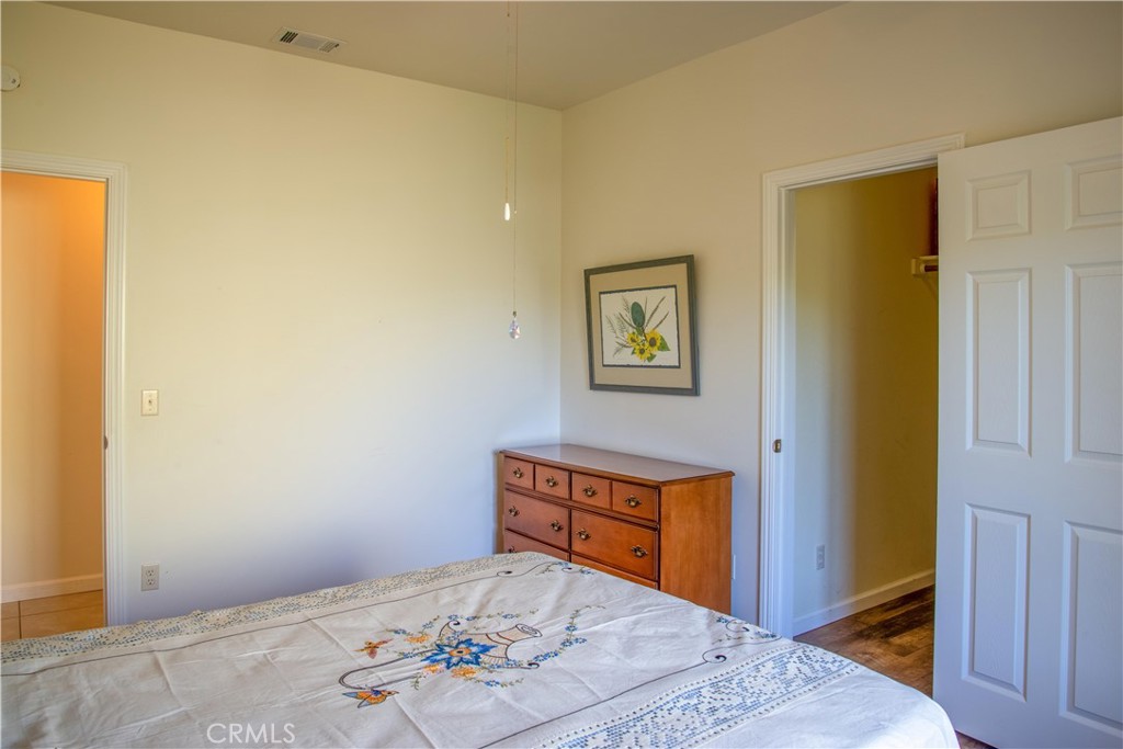 3199 Eton Road Cambria, CA 93428 - Photo 22 of 30 a bedroom with a bed and a dresser in it