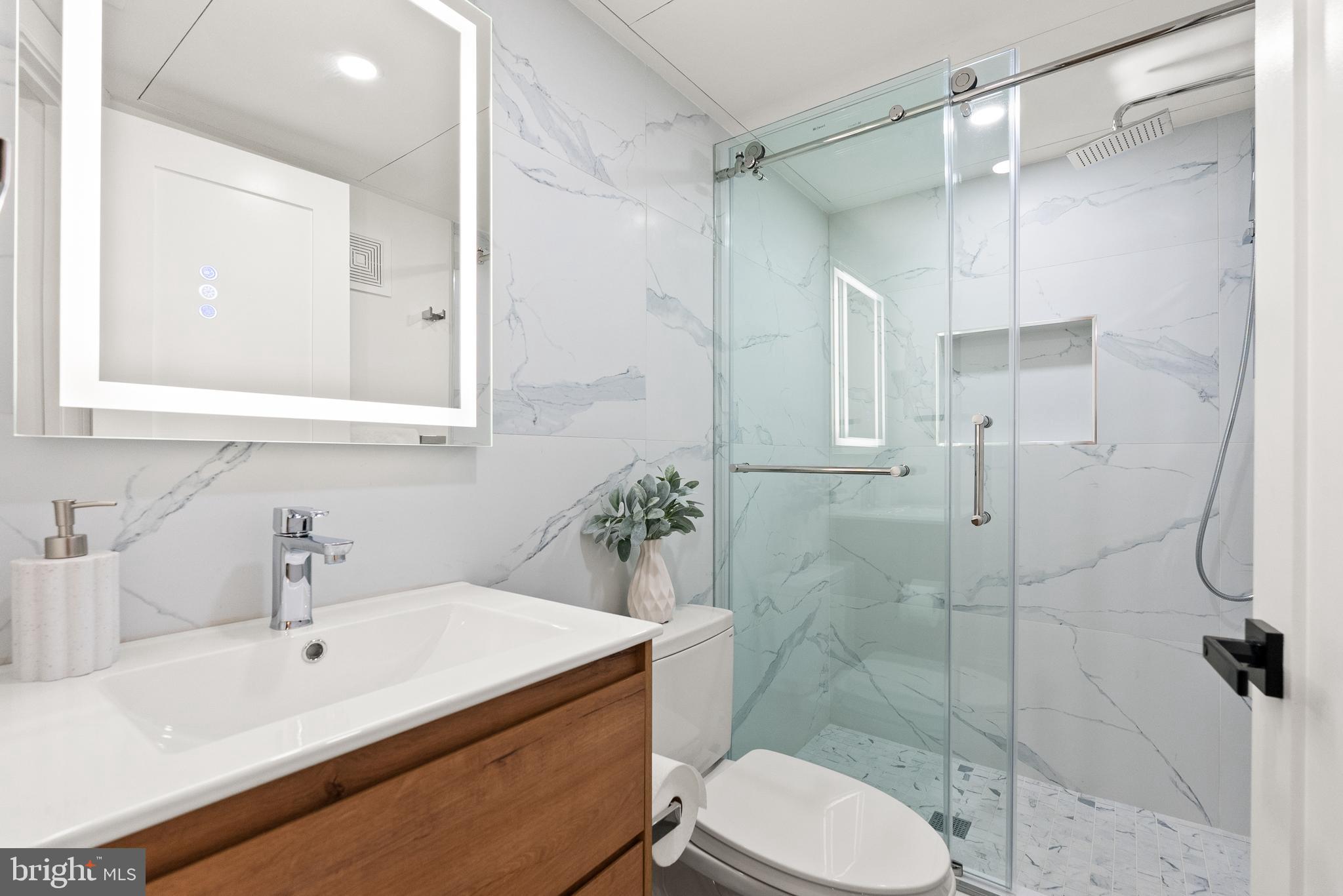 1714 Euclid Street Northwest, Unit 1 Washington, DC 20009 - Photo 14 of 24 a bathroom with a sink toilet and shower