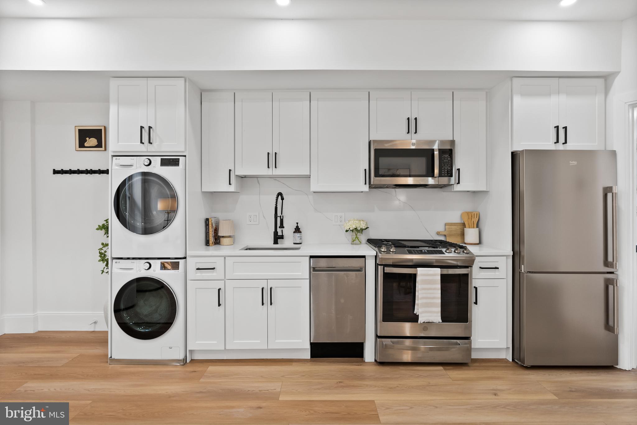 1714 Euclid Street Northwest, Unit 1 Washington, DC 20009 - Photo 3 of 24 Kitchen with beautiful finishes & LG washer/dryer