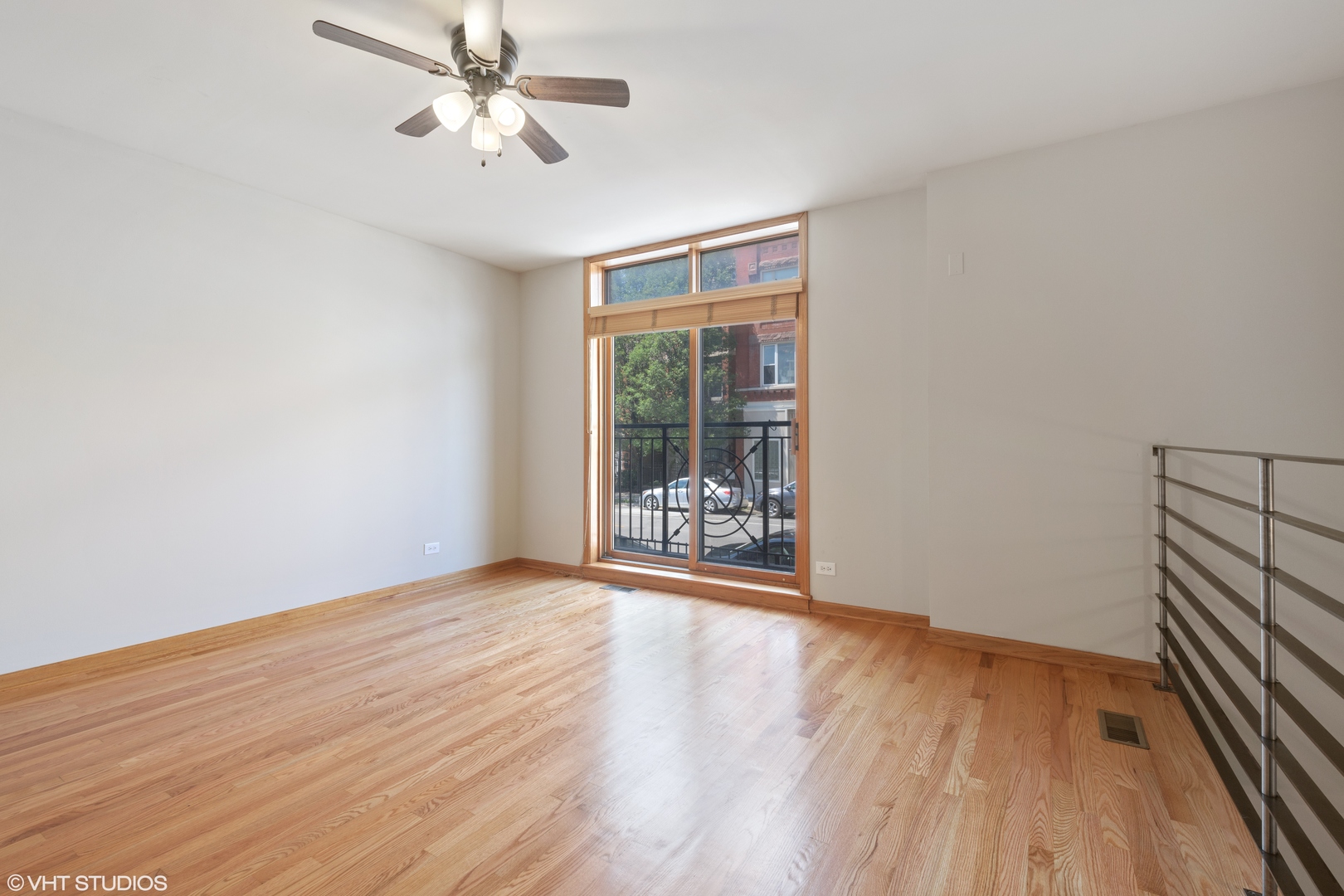 927 North Noble Street, Unit 1 Chicago, IL 60642 - Photo 2 of 10 wooden floor in an empty room with a window