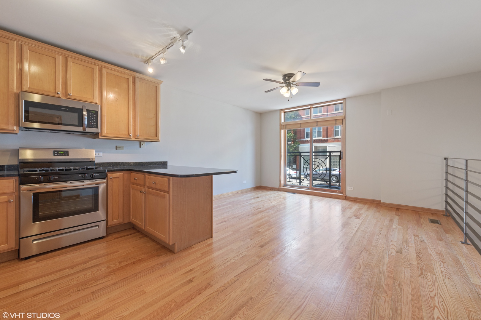 927 North Noble Street, Unit 1 Chicago, IL 60642 - Photo 3 of 10 a kitchen with wooden floors and stainless steel appliances