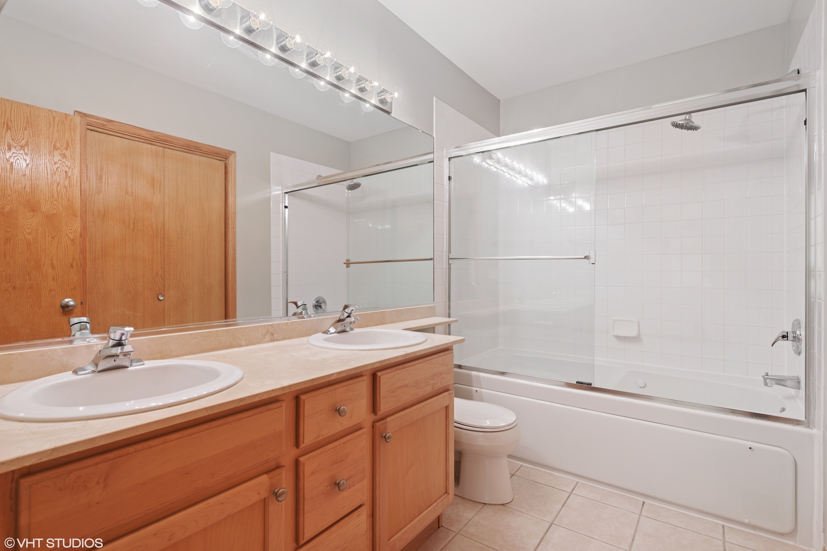 927 North Noble Street, Unit 1 Chicago, IL 60642 - Photo 6 of 10 a bathroom with a granite countertop sink a toilet and shower
