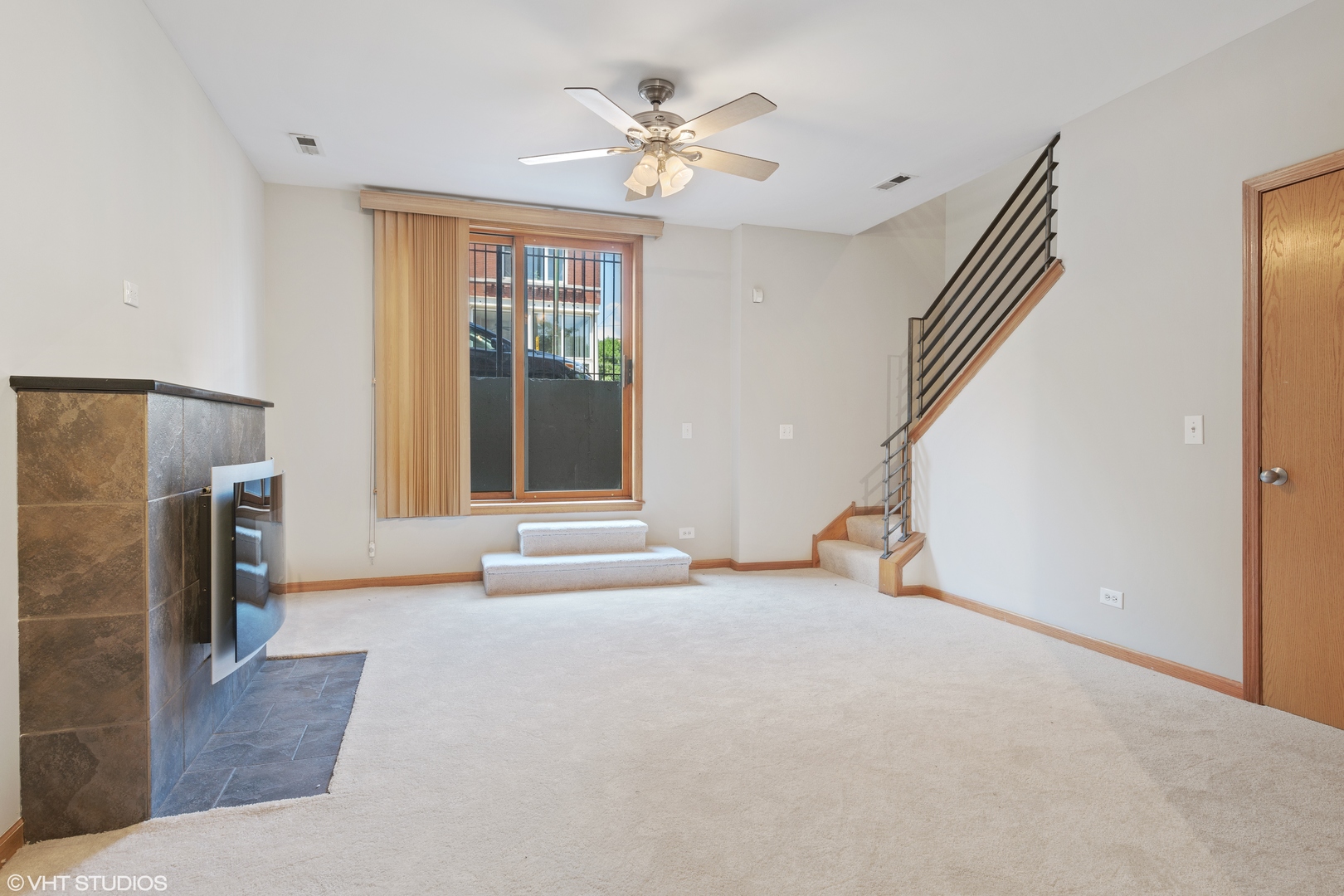 927 North Noble Street, Unit 1 Chicago, IL 60642 - Photo 8 of 10 an empty room with windows and a ceiling fan