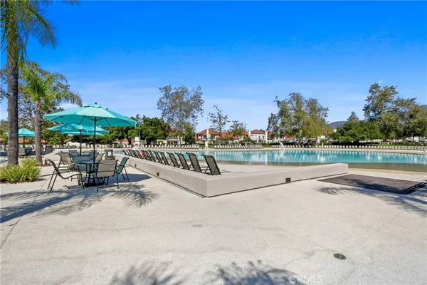 a view of swimming pool with outdoor seating and yard in back