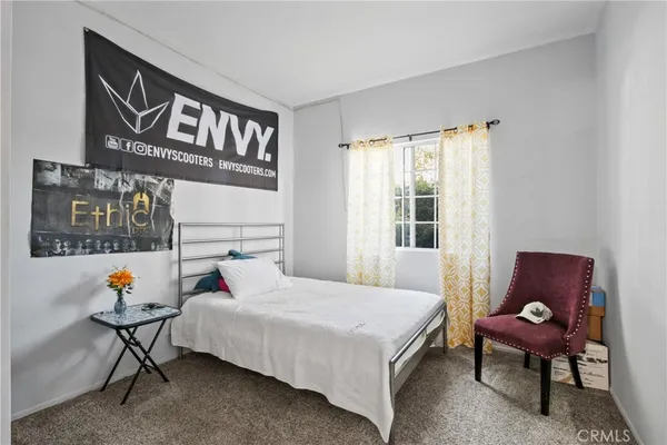 a bedroom with a bed and a window