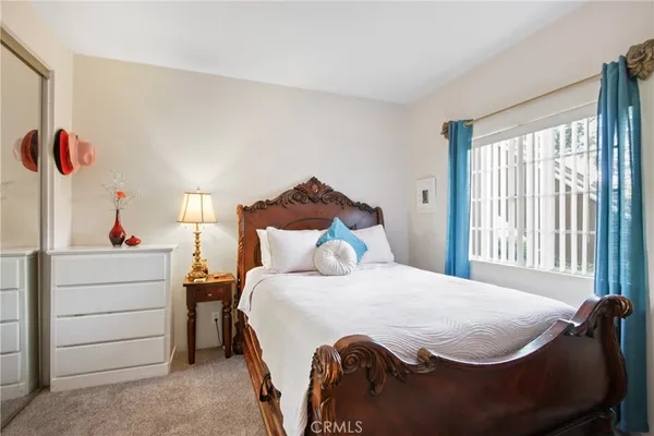a bedroom with a bed and a window