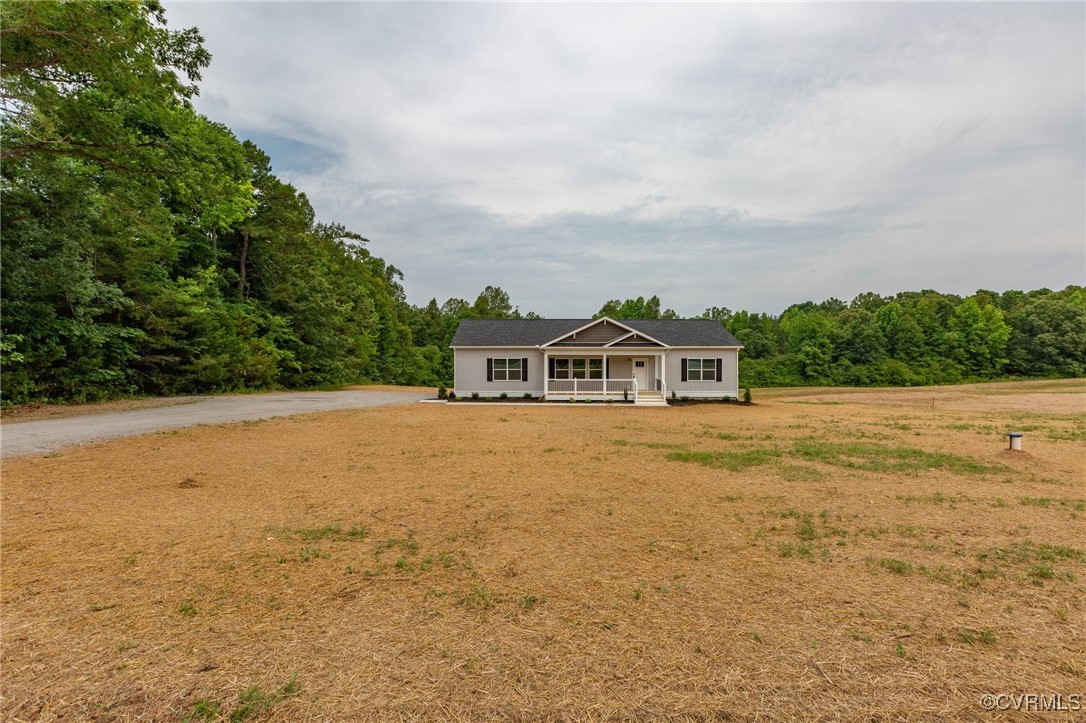 853 Levi Road Green Bay, VA 23942 - Photo 1 of 44 Ranch-style home with a forest view, a porch, and