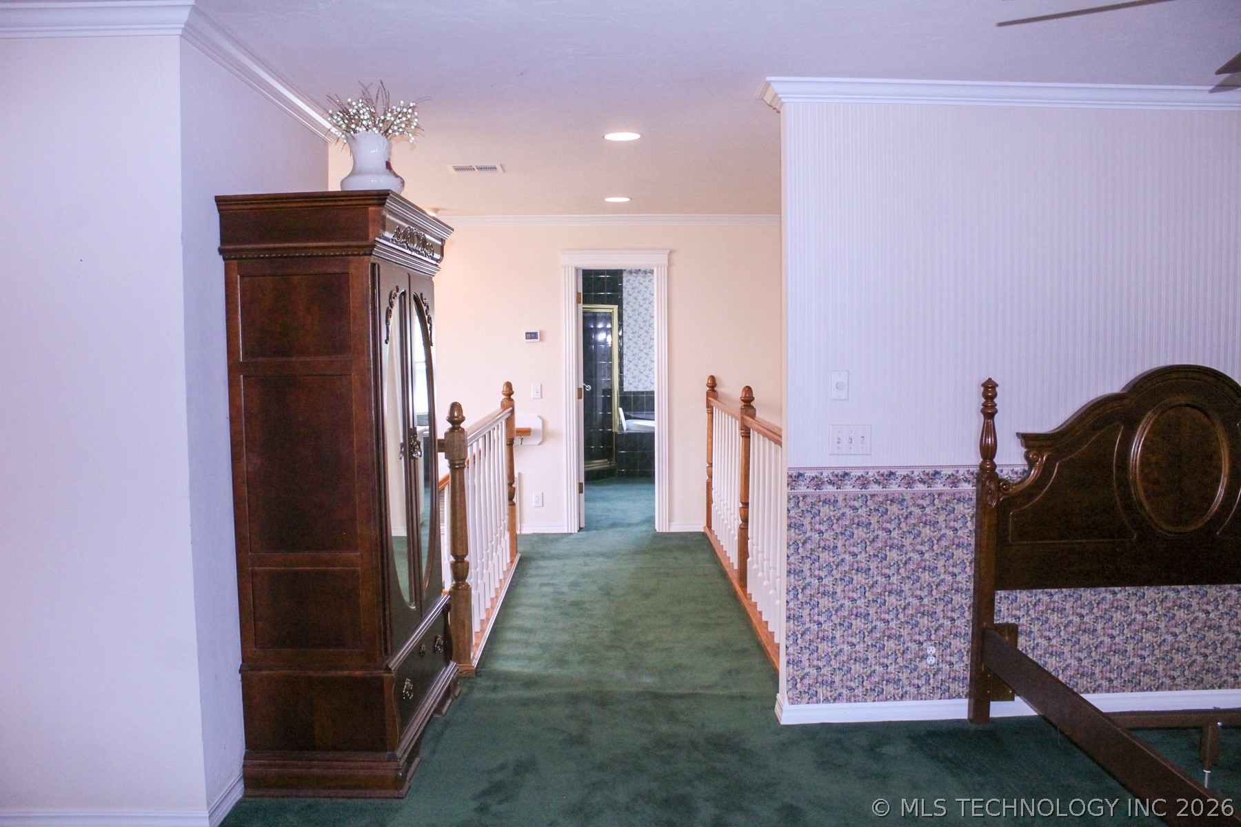13248 North 3540th Road Maud, OK 74854 - Photo 72 of 98 Hallway with green carpeting, white baseboards, and crown molding