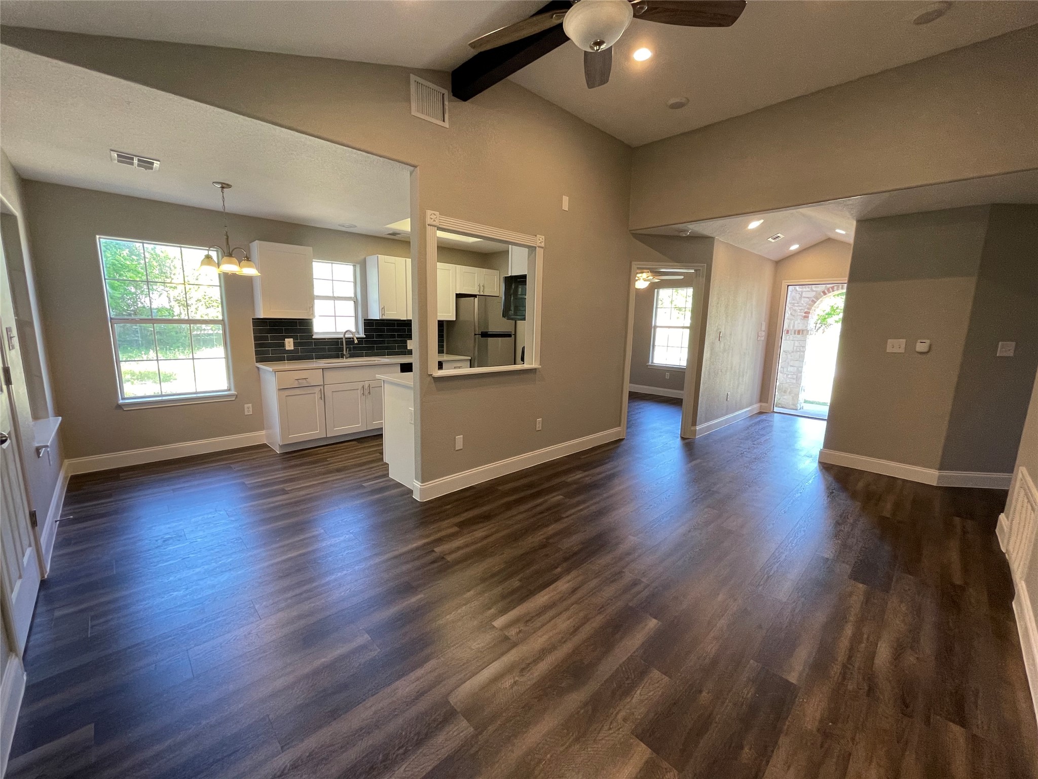 2004 Maple Street Georgetown, TX 78626 - Photo 12 of 31 Expansive open-concept living area featuring wood-finish flooring, vaulted ceilings, and recessed lighting