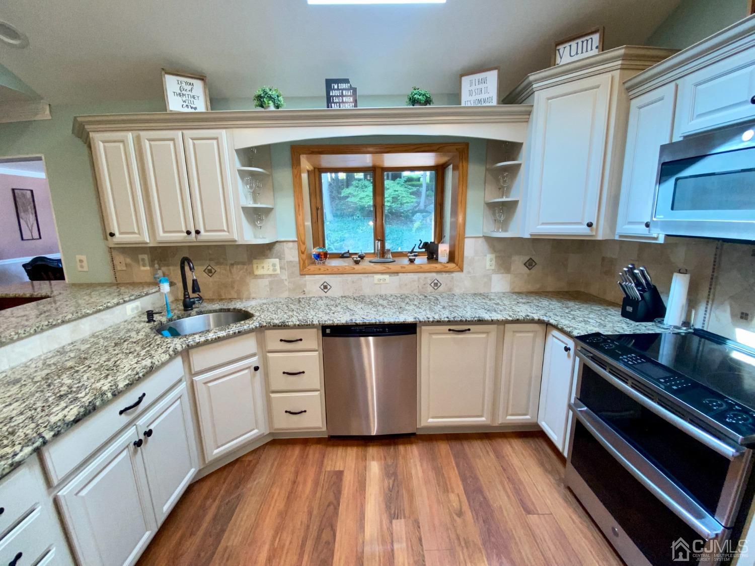 30 Woodland Road Franklin, NJ 07416 - Photo 15 of 34 a kitchen with granite countertop a sink stove and cabinets