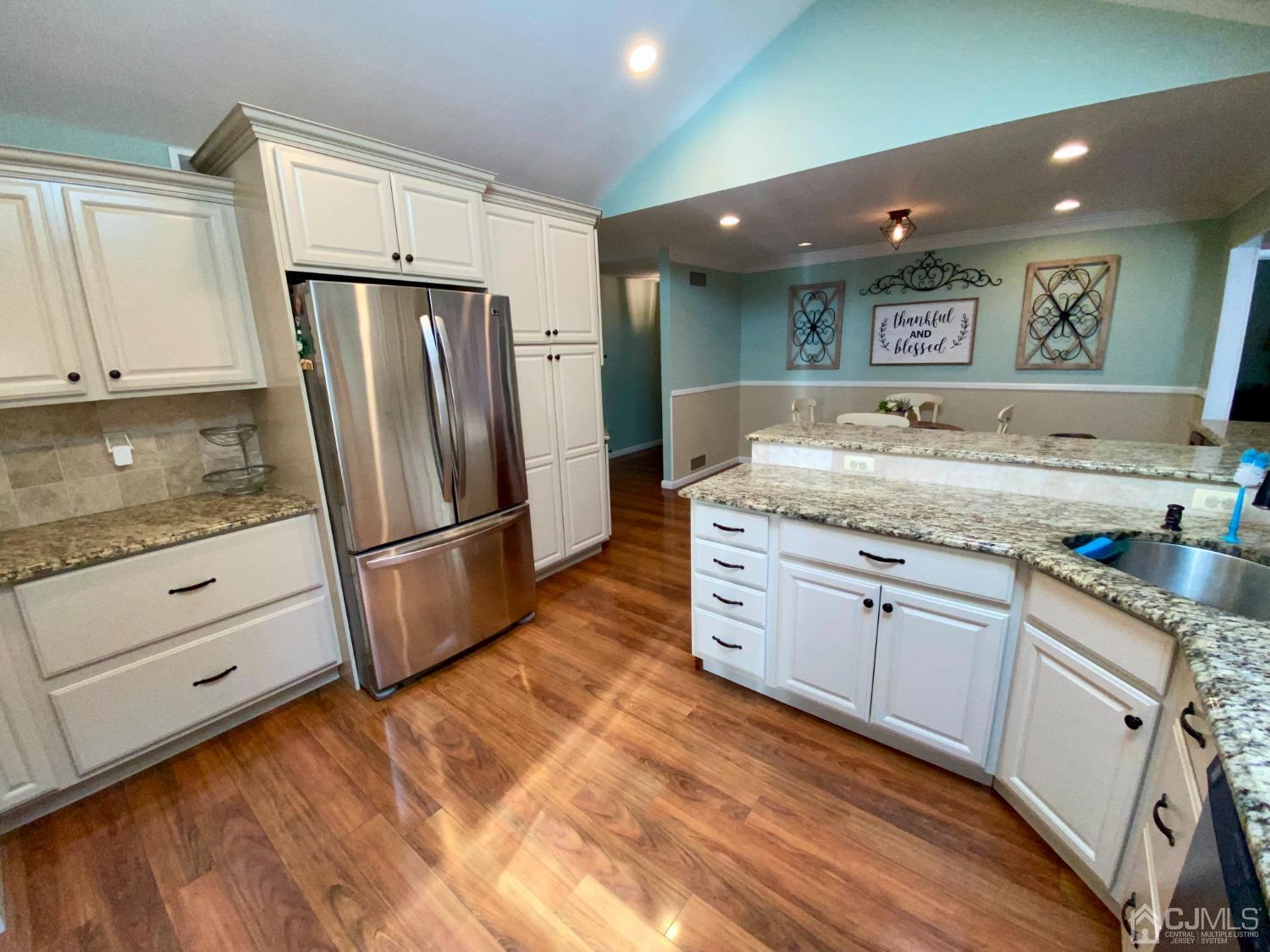 30 Woodland Road Franklin, NJ 07416 - Photo 16 of 34 a kitchen with granite countertop white cabinets and refrigerator