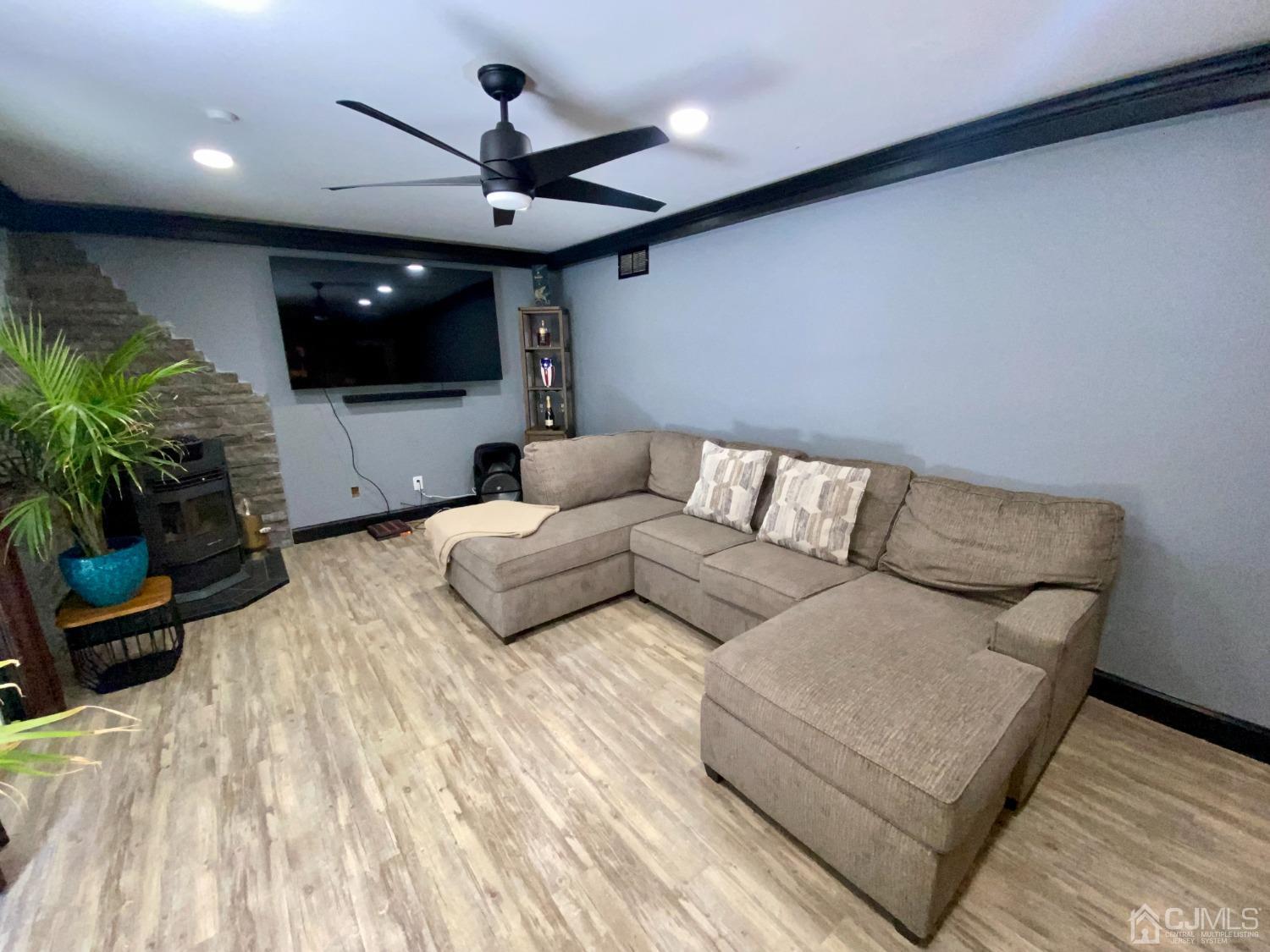 30 Woodland Road Franklin, NJ 07416 - Photo 22 of 34 a living room with furniture and a flat screen tv
