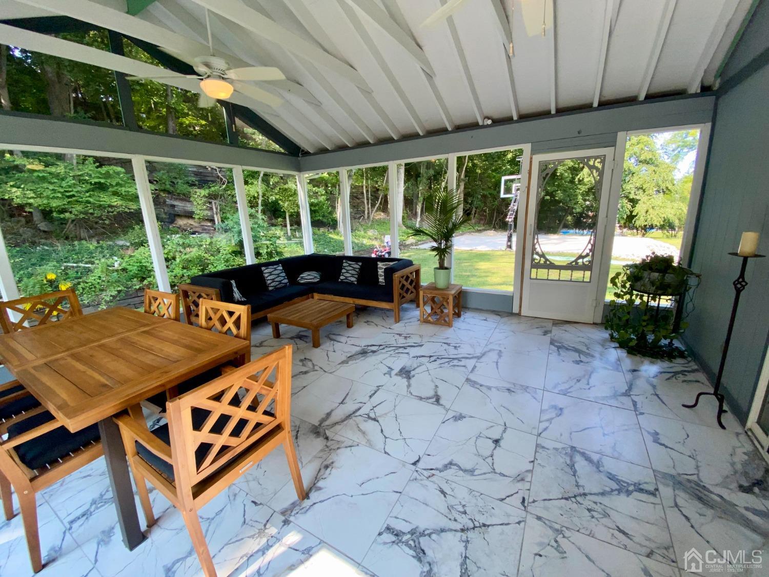 30 Woodland Road Franklin, NJ 07416 - Photo 24 of 34 a view of a patio with lawn chairs next to a yard