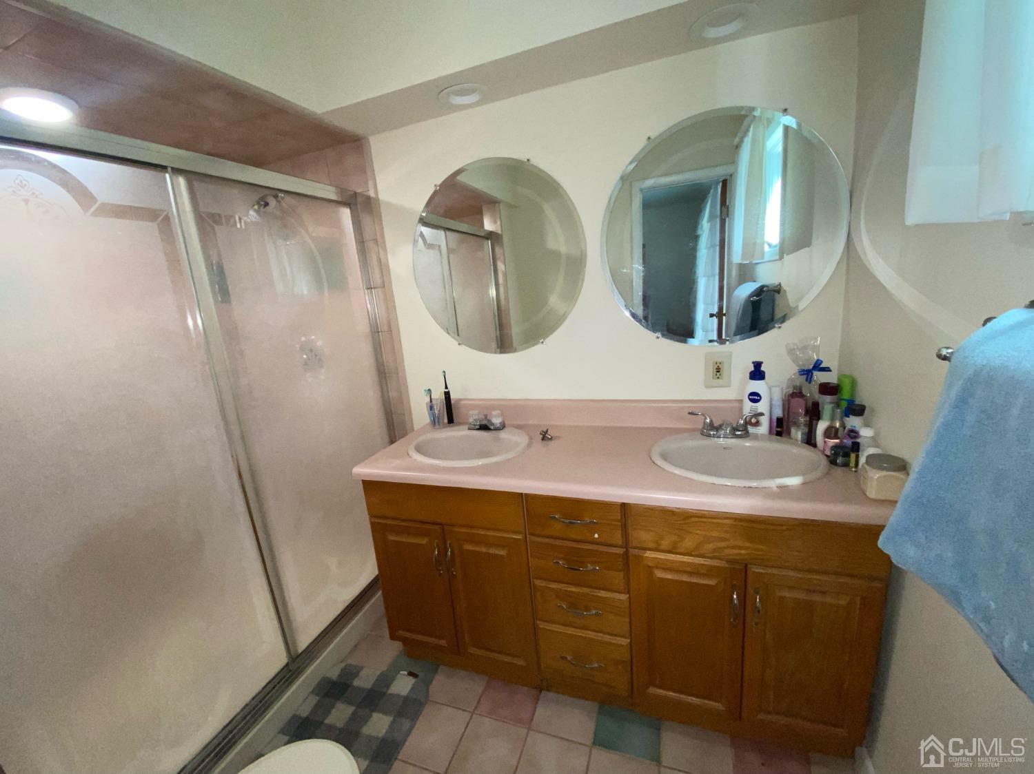 30 Woodland Road Franklin, NJ 07416 - Photo 9 of 34 a bathroom with a double vanity sink and mirror