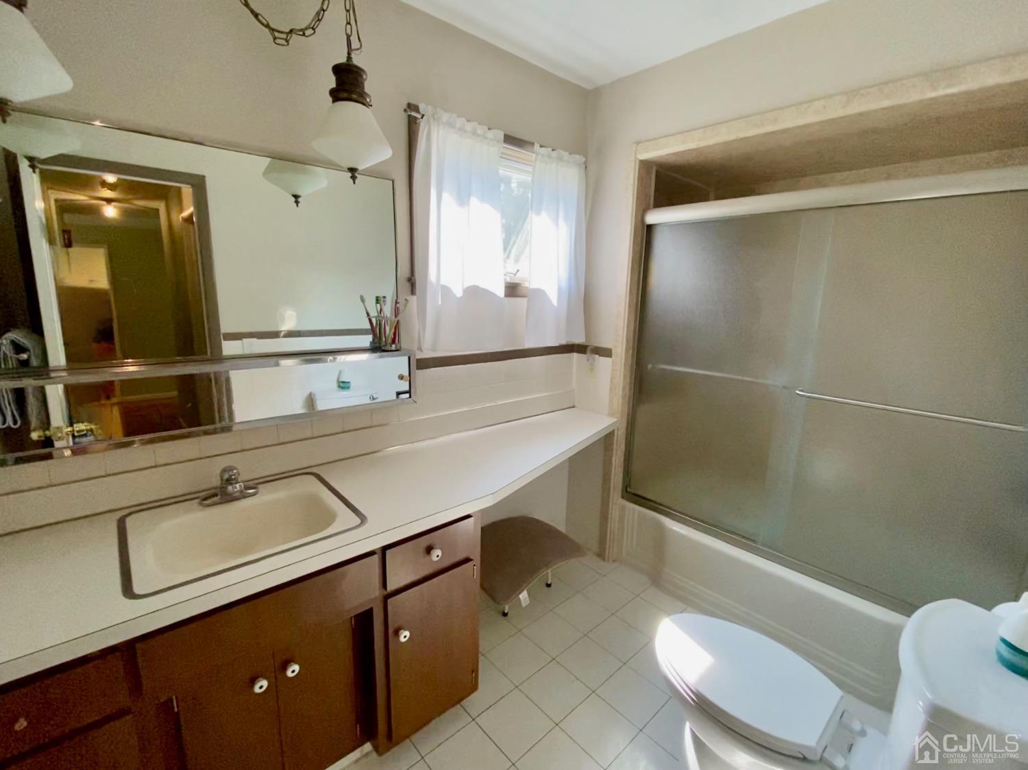 30 Woodland Road Franklin, NJ 07416 - Photo 10 of 34 a bathroom with a sink a toilet a mirror and shower
