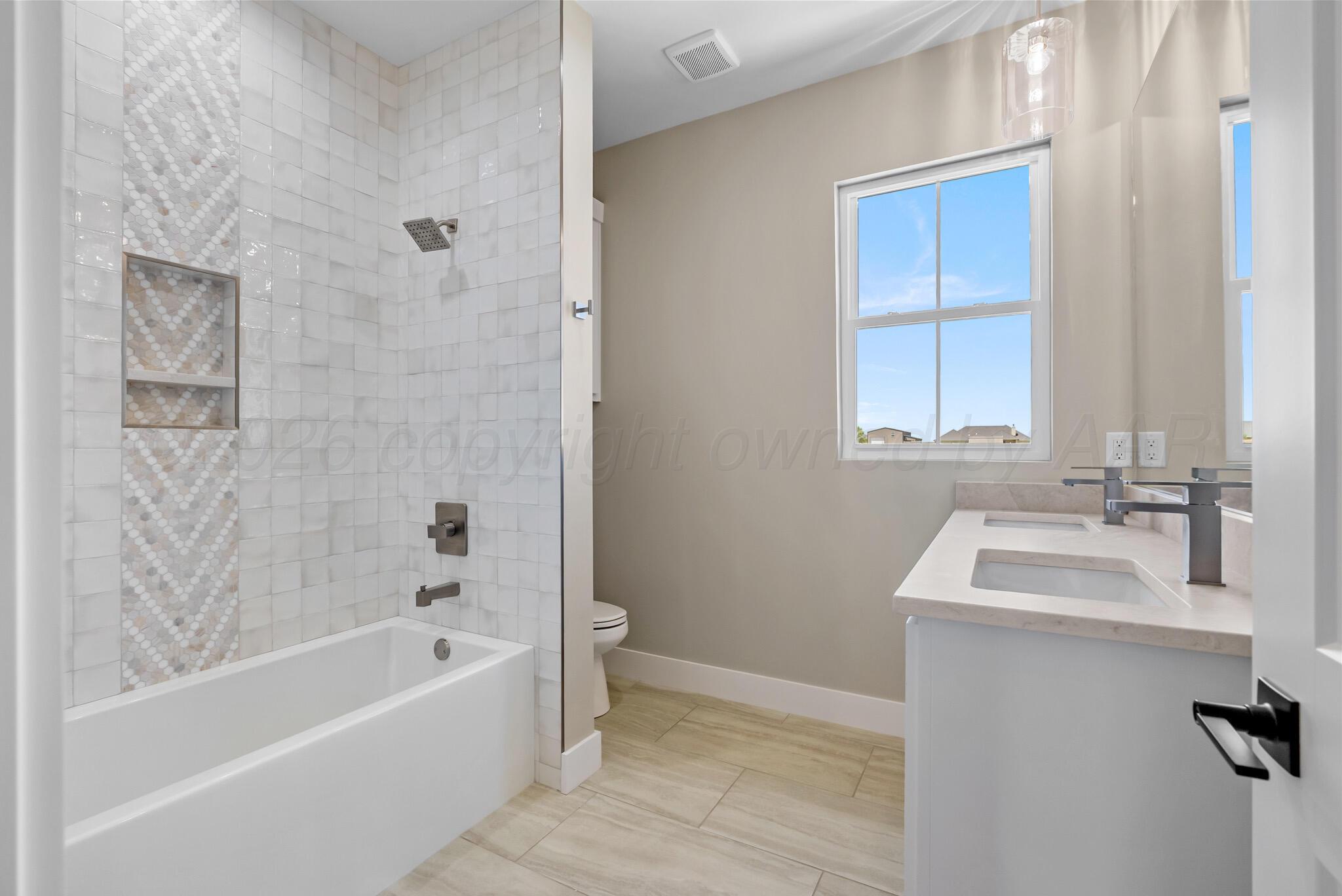 4201 Juniper Springs Road Amarillo, TX 79119 - Photo 16 of 27 a bathroom with a sink and a bathtub