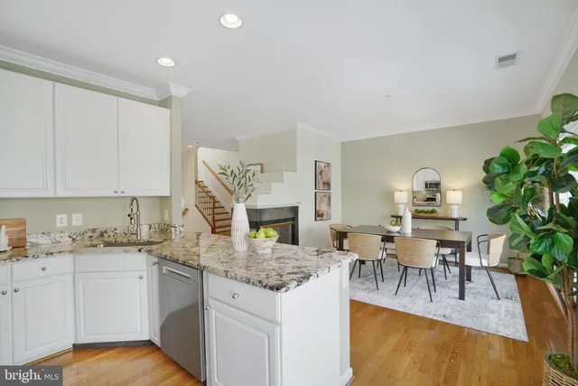 a kitchen with granite countertop a sink and a refrigerator