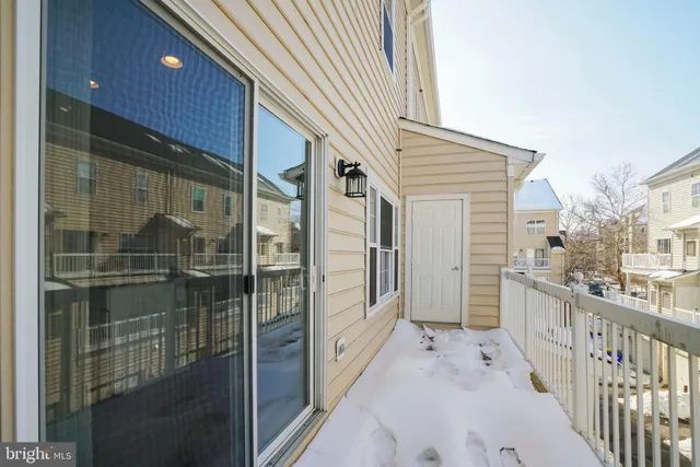 a kitchen with stainless steel appliances a dining table chairs and refrigerator