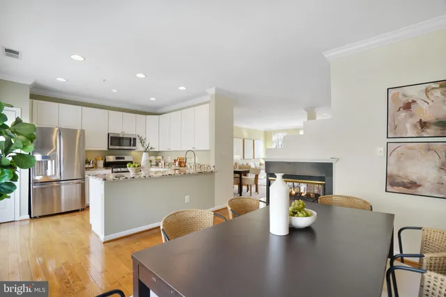 a view of a dining room with furniture and a potted plant