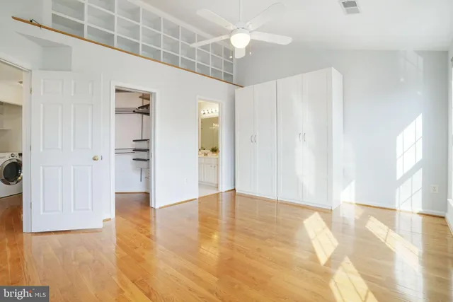 a view of an empty room with wooden floor