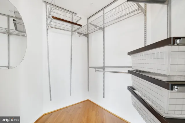 an empty room with a window and ceiling fan