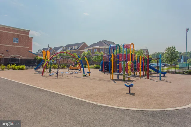 a view of a tennis ground with large trees