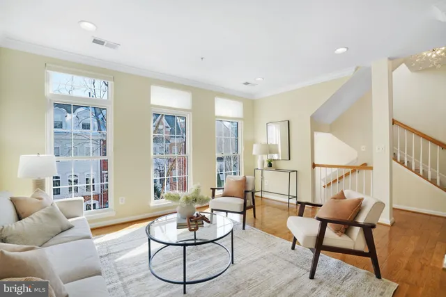 a living room with furniture and a dining table