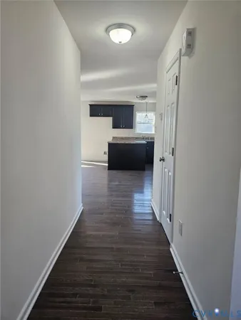 a view of a hallway view with wooden floor and staircase