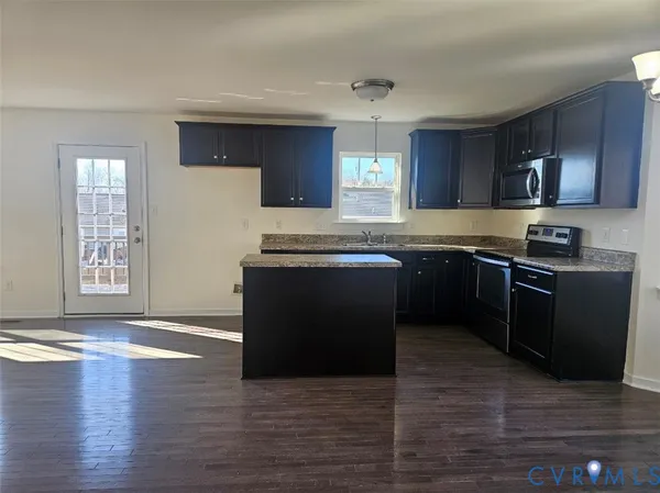 a kitchen with stainless steel appliances granite countertop a sink and a stove