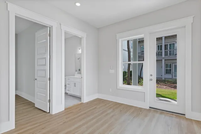 an empty room with windows and closet