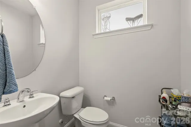 a white toilet sitting next to a bathroom sink