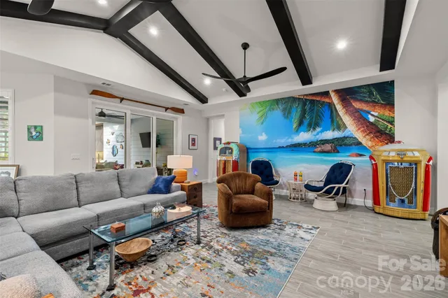 a living room with furniture a flat screen tv and rug