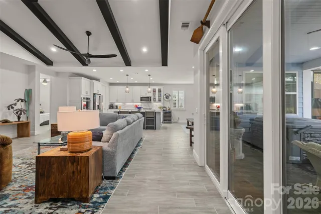 a living room with furniture and a chandelier