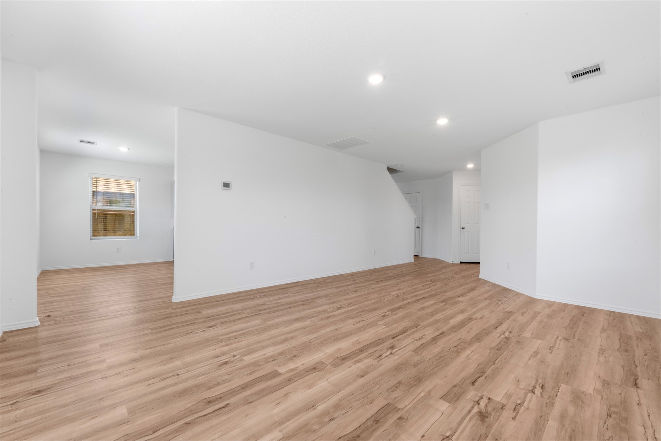 14602 Broadbury Pond Road Rosharon, TX 77583 - Photo 9 of 22 a view of an empty room with wooden floor and a window