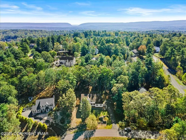 a view of a kitchen with wooden floor and electronic appliances