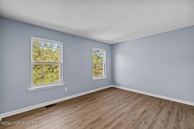an aerial view of a house with a yard basket ball court and outdoor seating