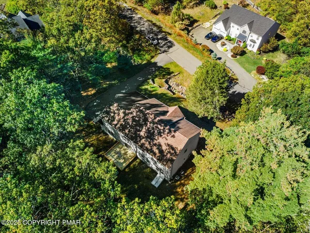 a view of a house with a yard and street