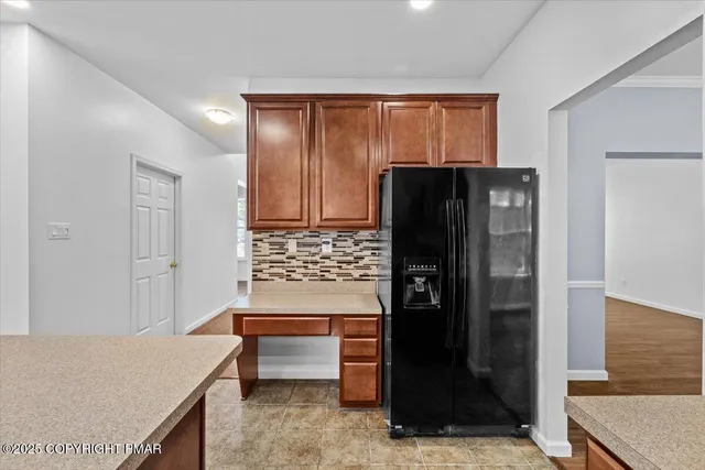 a kitchen with stainless steel appliances granite countertop a stove top oven a sink dishwasher a refrigerator and a stove