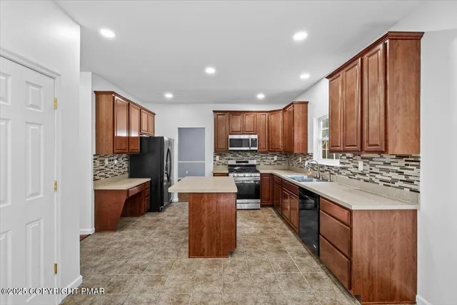 a kitchen with wooden cabinets and stainless steel appliances