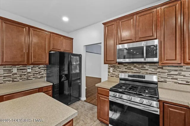 a kitchen with a refrigerator and a sink