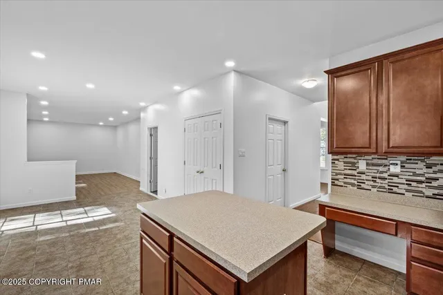 an aerial view of a city with lots of residential buildings and mountain view in back