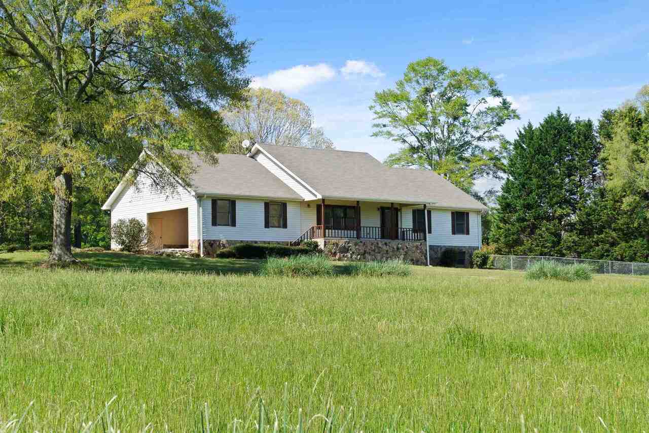 595 Five Points Road Milner, GA 30257 - Photo 1 of 1 a front view of a house with yard and green space