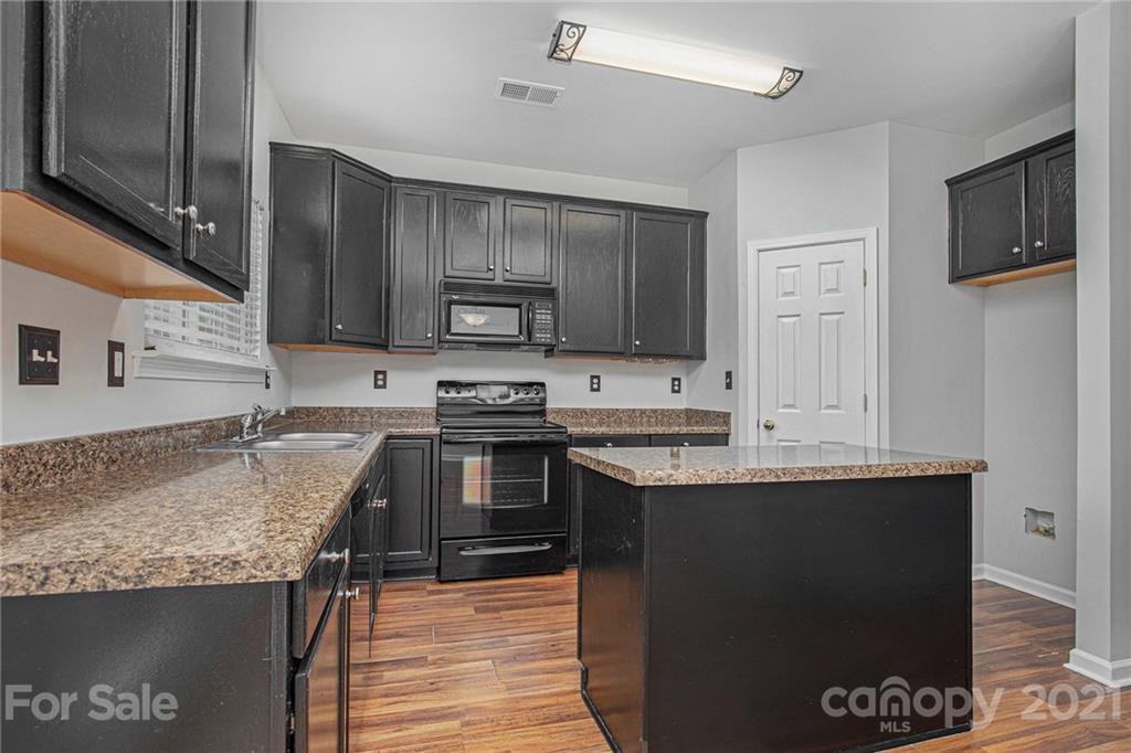 9230 Washam Potts Road Cornelius, NC 28031 - Photo 3 of 31 a kitchen with stainless steel appliances granite countertop a stove refrigerator sink and microwave