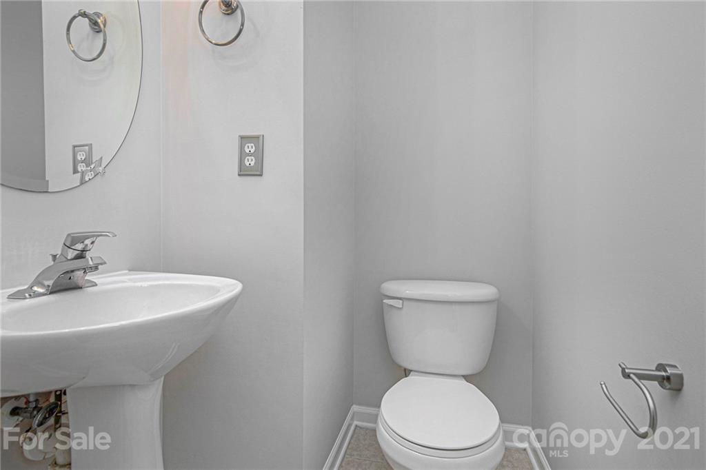 9230 Washam Potts Road Cornelius, NC 28031 - Photo 21 of 31 a bathroom with a toilet a sink and a mirror