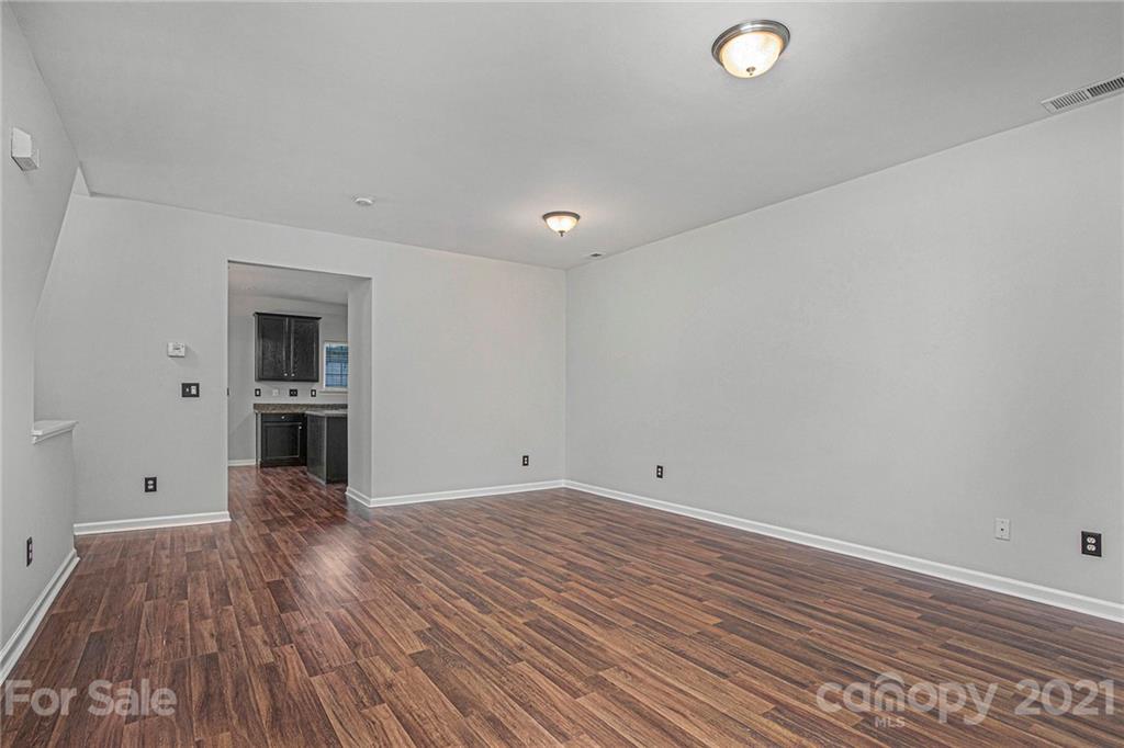 9230 Washam Potts Road Cornelius, NC 28031 - Photo 8 of 31 wooden floor in an empty room with a window