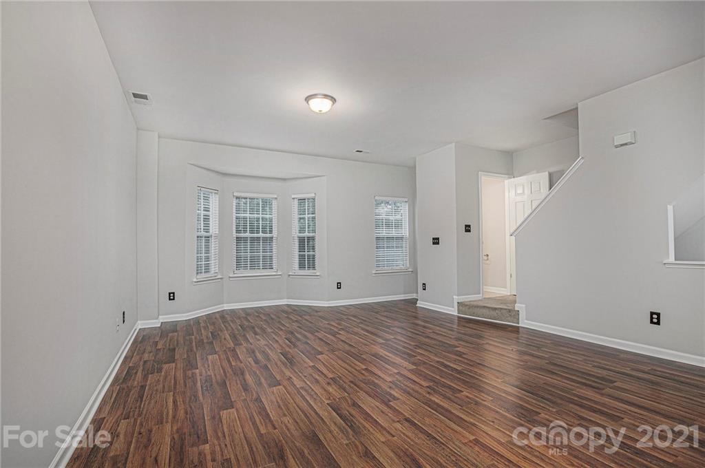 9230 Washam Potts Road Cornelius, NC 28031 - Photo 10 of 31 wooden floor in an empty room with a window