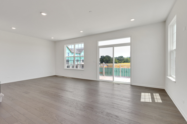 1627 Sager Way Batavia, IL 60510 - Photo 11 of 25 a view of an empty room with wooden floor and a window