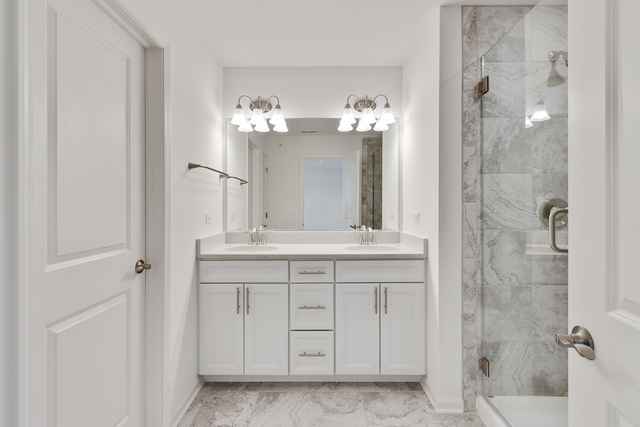 1627 Sager Way Batavia, IL 60510 - Photo 17 of 25 a bathroom with a double vanity sink shower and a mirror