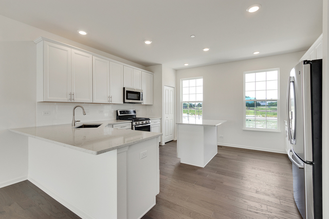 1627 Sager Way Batavia, IL 60510 - Photo 5 of 25 a kitchen with sink a microwave and cabinets